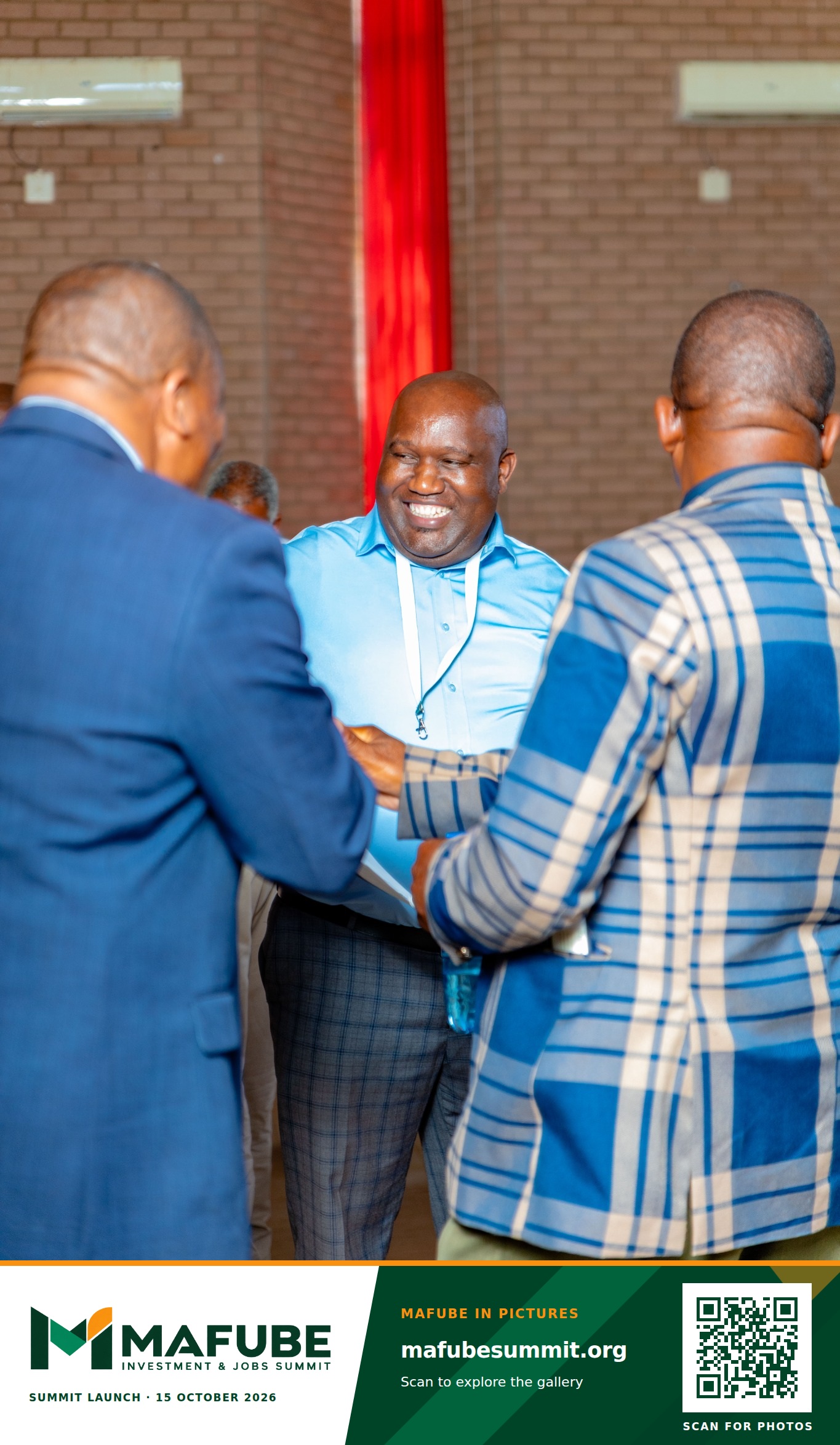 Participants greet one another with a handshake, with the Mafube Investment & Jobs Summit photo footer